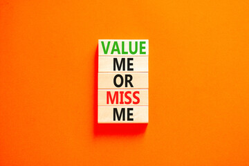 Value or miss me symbol. Concept words Value me or miss me on wooden block. Beautiful orange table orange background. Business psychological and value or miss me concept. Copy space.