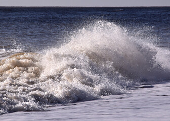 waves crashing on the beach in west England