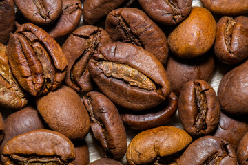 A coffee bean is a seed of the Coffea plant and the source for coffee. It is the pip inside the red or purple fruit. This fruit is often referred to as a coffee cherry