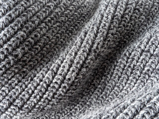 Crumpled gray knitted woolen fabric closeup