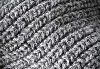 Texture of gray knitted woolen fabric closeup