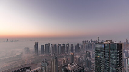 Panorama of Dubai Marina with JLT skyscrapers and golf course night to day timelapse, Dubai, United Arab Emirates.