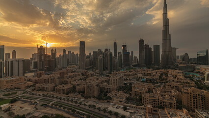 Fototapeta na wymiar Sunset over Dubai Downtown timelapse with tallest skyscraper and other towers