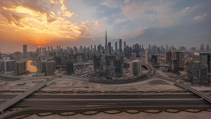 Naklejka na ściany i meble Sunset over panoramic skyline of Dubai with business bay and downtown district timelapse.