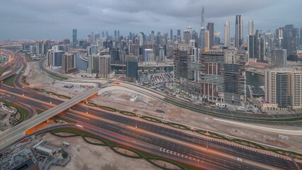 Panoramic skyline of Dubai with business bay and downtown district night to day timelapse.