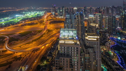 Dubai marina and JLT skyscrapers along Sheikh Zayed Road aerial day to night timelapse.