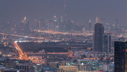 Dubai Downtown skyline row of skyscrapers with tallset tower aerial day to night timelapse. UAE