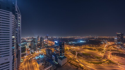Obraz premium Aerial view of media city and al barsha heights district area all night timelapse from Dubai marina.