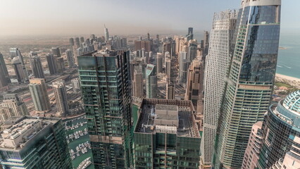 Panorama showing Dubai Marina and JLT with JBR district. Ttraffic on highway between skyscrapers aerial timelapse.