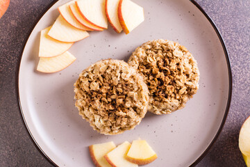 Closeup of apple crumble pancakes and fresh apples on plate. Homemade desserts. Top view