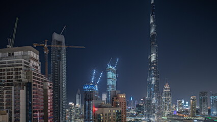 Obraz na płótnie Canvas Panorama showing aerial cityscape night timelapse with illuminated architecture of Dubai downtown.
