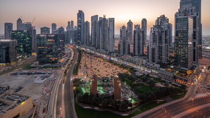 Bay Avenue with modern towers residential development in Business Bay aerial panoramic day to night timelapse, Dubai