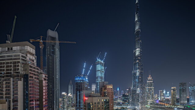 Panorama showing aerial cityscape night timelapse with illuminated architecture of Dubai downtown. © neiezhmakov