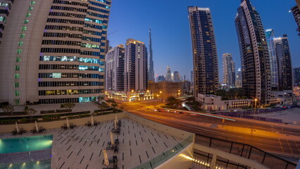 Fototapeta na wymiar Aerial panorama of Dubai downtown and difc skyscrapers day to night timelapse.