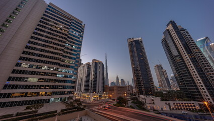 Aerial panoramic view to Dubai downtown and difc skyscrapers day to night timelapse.