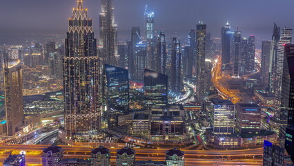 Aerial view of tallest towers in Dubai Downtown skyline and highway day to night timelapse.