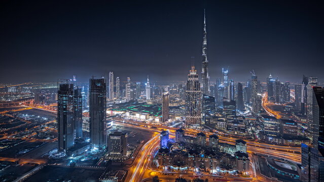 Panorama showing aerial view of tallest towers in Dubai Downtown skyline and highway night timelapse. © neiezhmakov