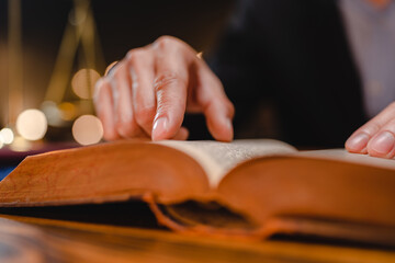 businessman or legal expert reviewing document reports at office workplace with computer laptop, professional lawyer reading and checking financial documents or insurance and sign a contract by pen