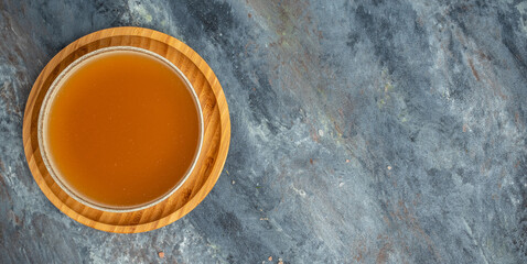 Bone meat pork broth in bowl on a dark background. Long banner format. top view