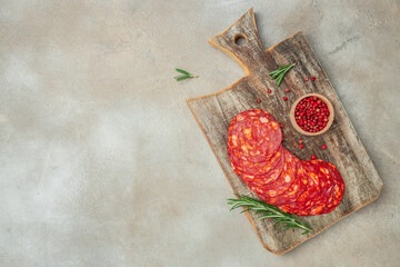 Spanish traditional chorizo sausage on a wooden board. banner, menu, recipe place for text, top view - obrazy, fototapety, plakaty