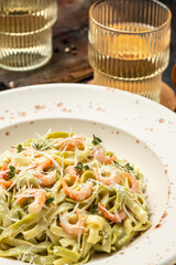 pasta fettuccine or tagliatelle with seafood rich cream. Cooking mediterranean food with savory prawns,Restaurant menu, dieting, cookbook recipe top view