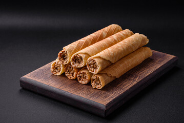 Delicious crispy wafer rolls with cream filling with nuts