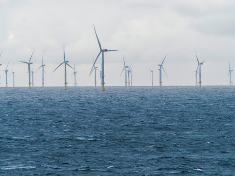 Offshore and Onshore Windmill farm Westermeerwind, Windmill park in the Netherlands with huge large wind turbines, group of windmills for renewable electric energy
