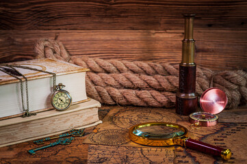 Old items, book, pocket watch, compass, magnifying glass, spyglass, old maps, thick rope