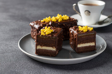 Chocolate almond brownie with mango and passionfruit jam covered gourmet chocolate glaze on gray background