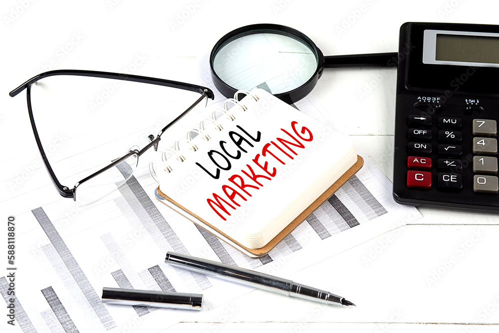 Aufkleber local marketing text on notebook with calculator on diagram background