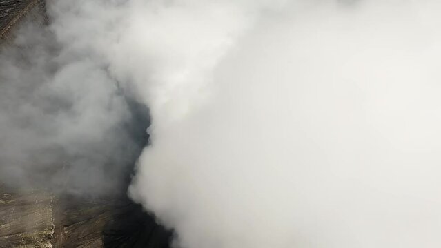  Flight through the smoke from the vent of the volcano. Volcano in indonesia.