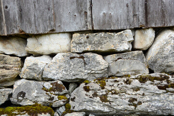 stone wall background with old weathered wooden planks