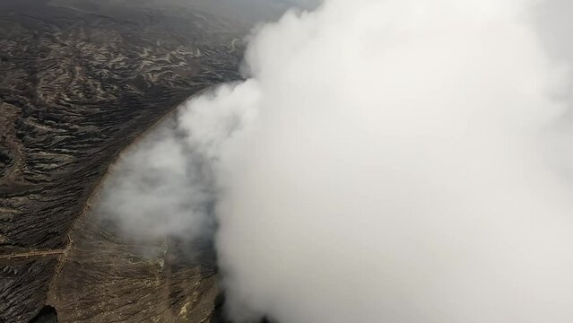 Flight through the smoke from the vent of the volcano. Volcano in indonesia.