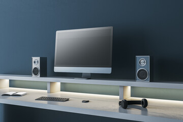 Modern dark blue designer workspace with empty mock up computer screen, loud speakers and other items. 3D Rendering.