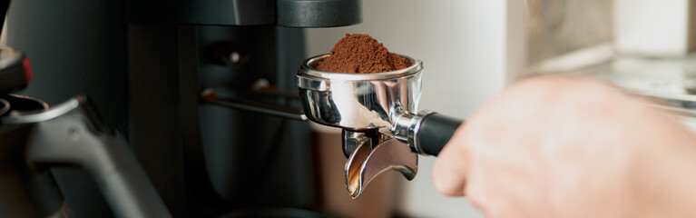 Process of pouring ground coffee into the filter from the coffee grinder