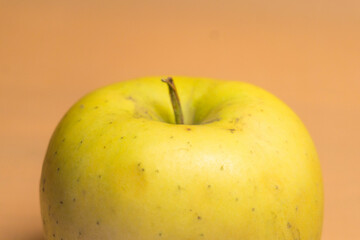 yellow apple on orange background