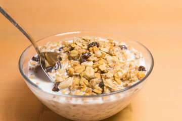 muesli in a glass bowl with milk