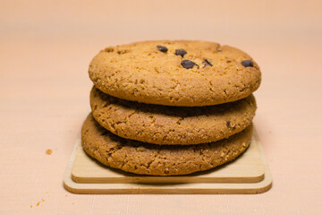 oatmeal cookies with chocolate on orange background