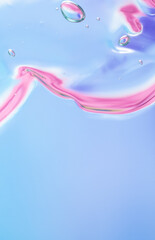 Gel texture of cosmetic products. Pink blue translucent skin care cream with bubbles. macro photo