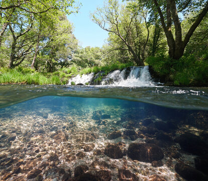 Small waterfall on a river, over and under water surface, split level view, Spain, Galicia, Rio Verdugo