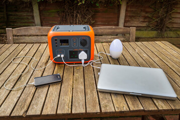 Portable electric power station solar electricity generator with laptop, cell phone, lamp charging. 