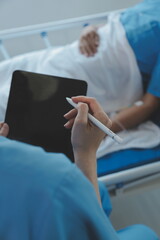 Women Asian doctors hold the patient hand and encourage and provide medical advice While checking...