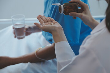 Women Asian doctors hold the patient hand and encourage and provide medical advice While checking...