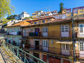 Old, colorful closed buildings in Porto, Portugal close to the Douro, Rua de Restauracao. Image taken on a sunny day in April.