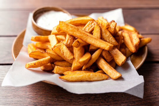 French fries, pommes frites on a plate with mayonaise, salty snack
