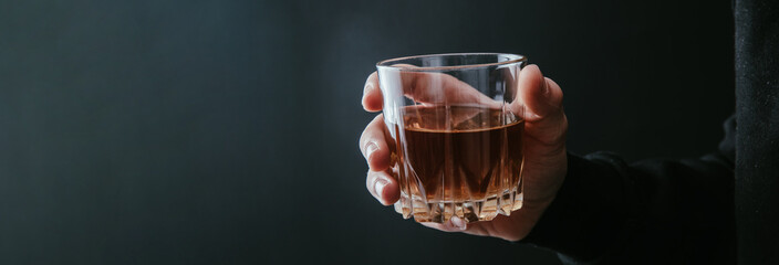 man holding glass of alcohol