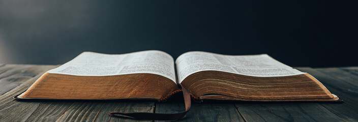 open Holy Bible on the wooden table