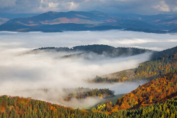 Mountain landscape with foggy valley during autumn morning. The Sulov Rocks, national nature reserve in northwest of Slovakia, Europe.