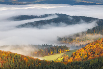 Mountain landscape with foggy valley during autumn morning. The Sulov Rocks, national nature reserve in northwest of Slovakia, Europe.