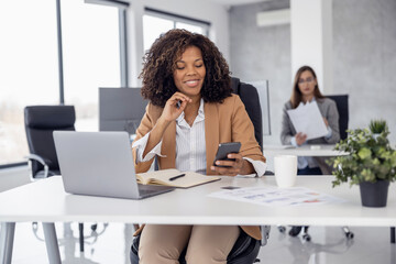 Multiethnic business women working together on computer in modern office